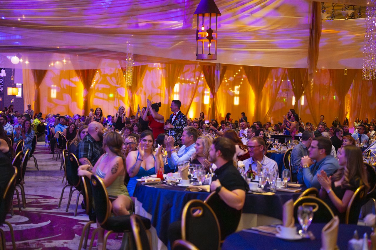 Renown tables cheering from the front of the ballroom