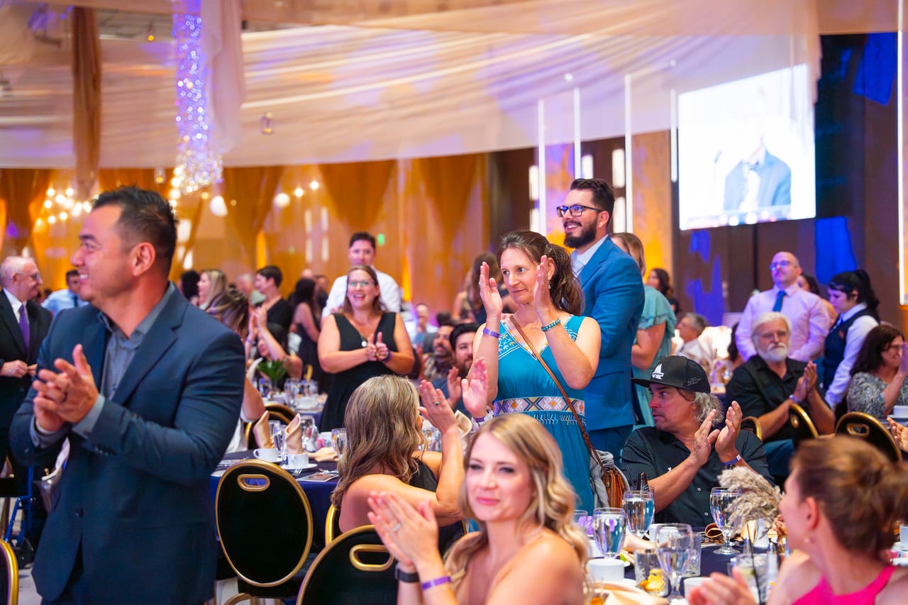 Renown guests giving a standing ovation from their tables