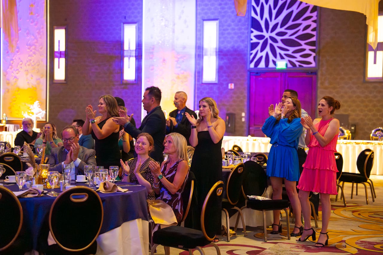 Renown guests standing and cheering from their tables