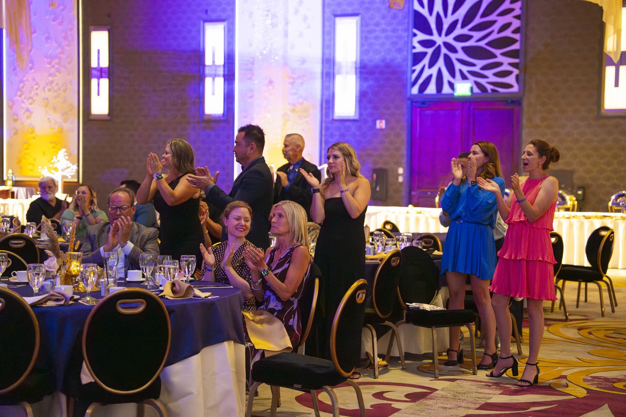Renown guests standing at their tables to applaud
