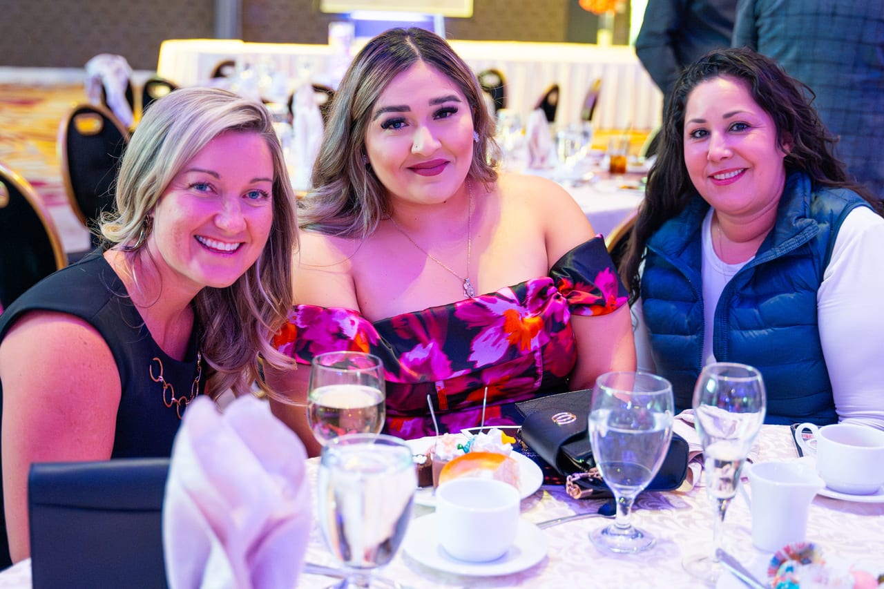 Three Renown coworkers smiling together at their dinner table
