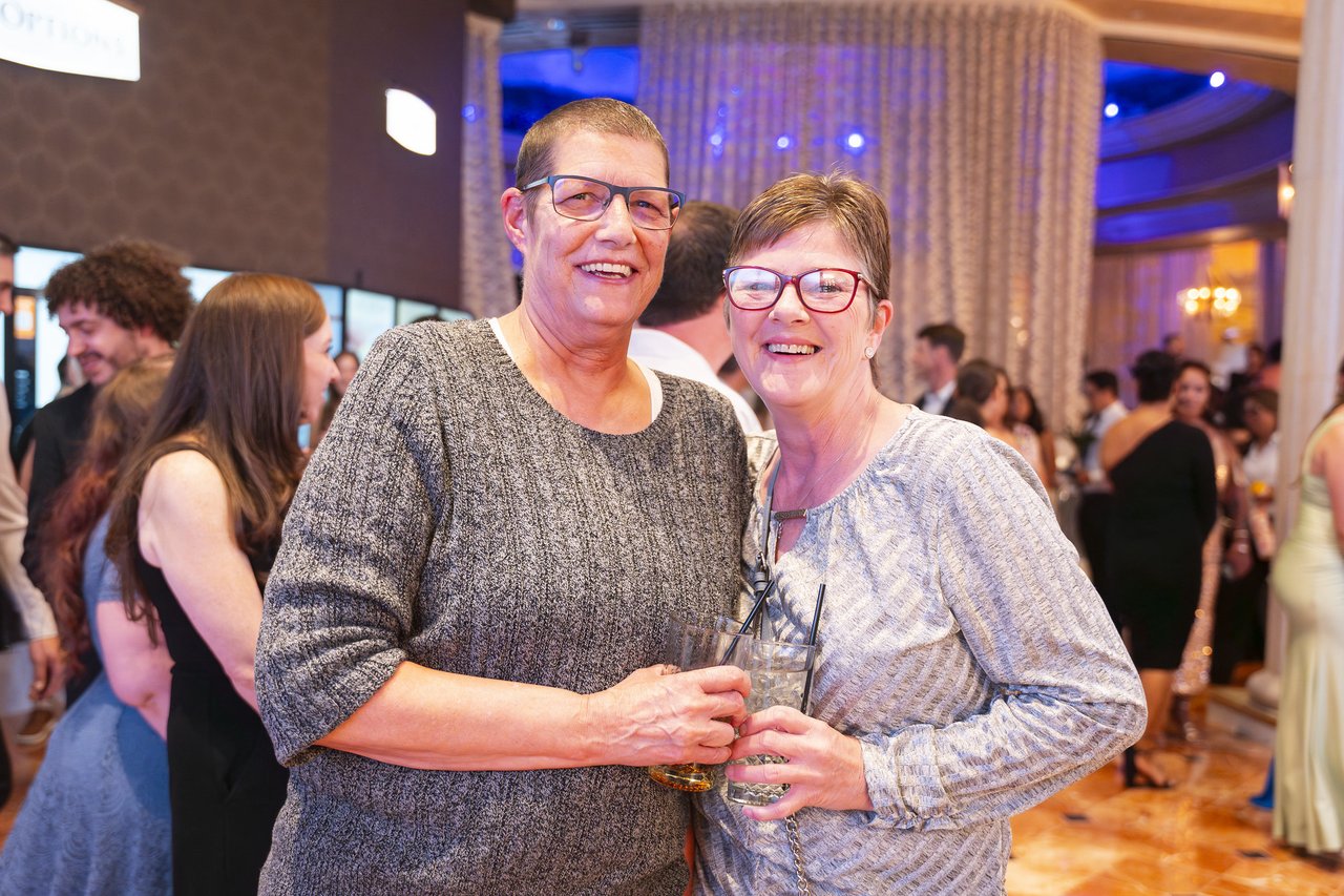 Two Renown friends smiling together in the crowd
