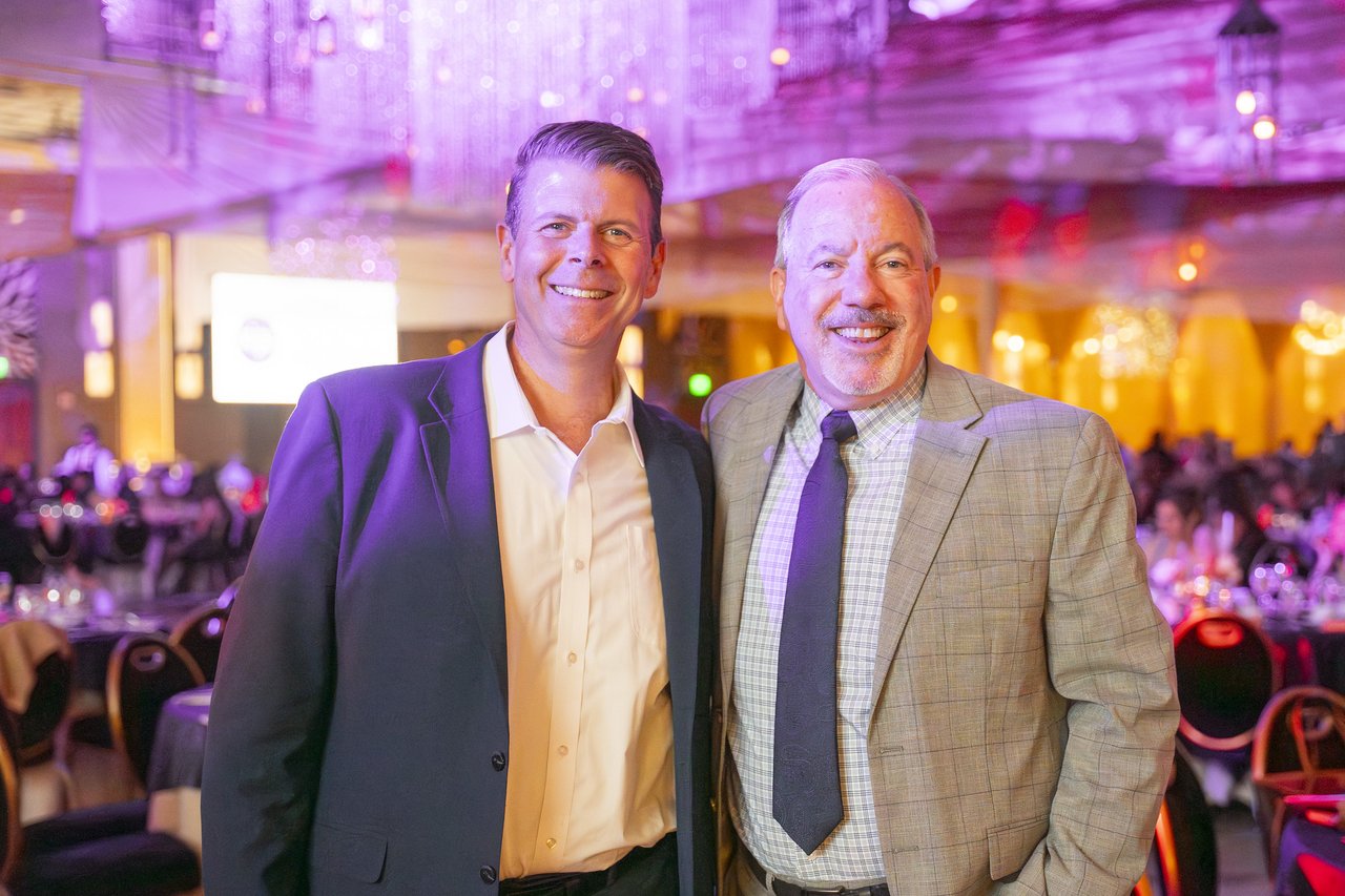 Two Renown leaders smiling together in the ballroom