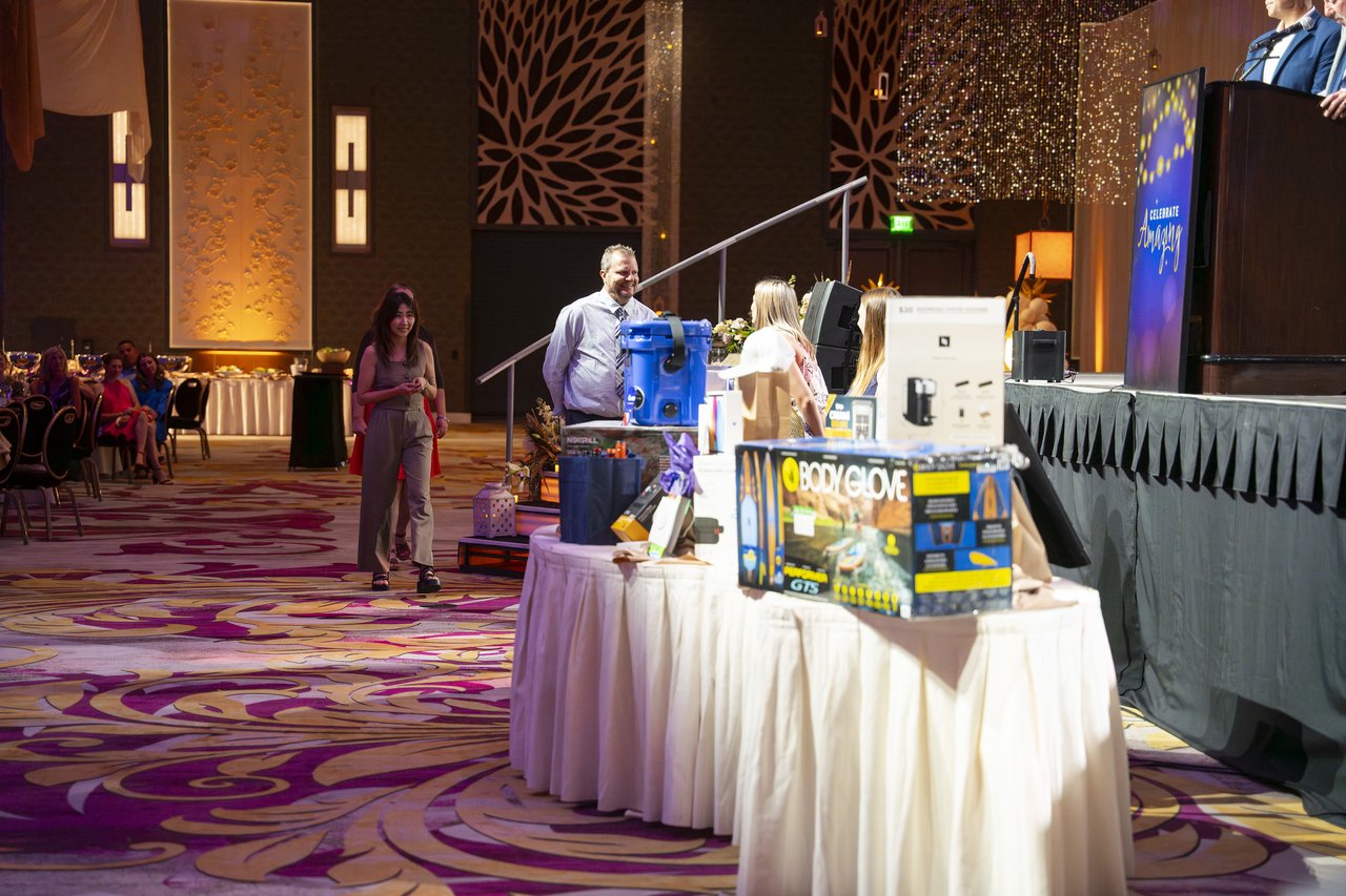 A Renown guest walking up to the prize table