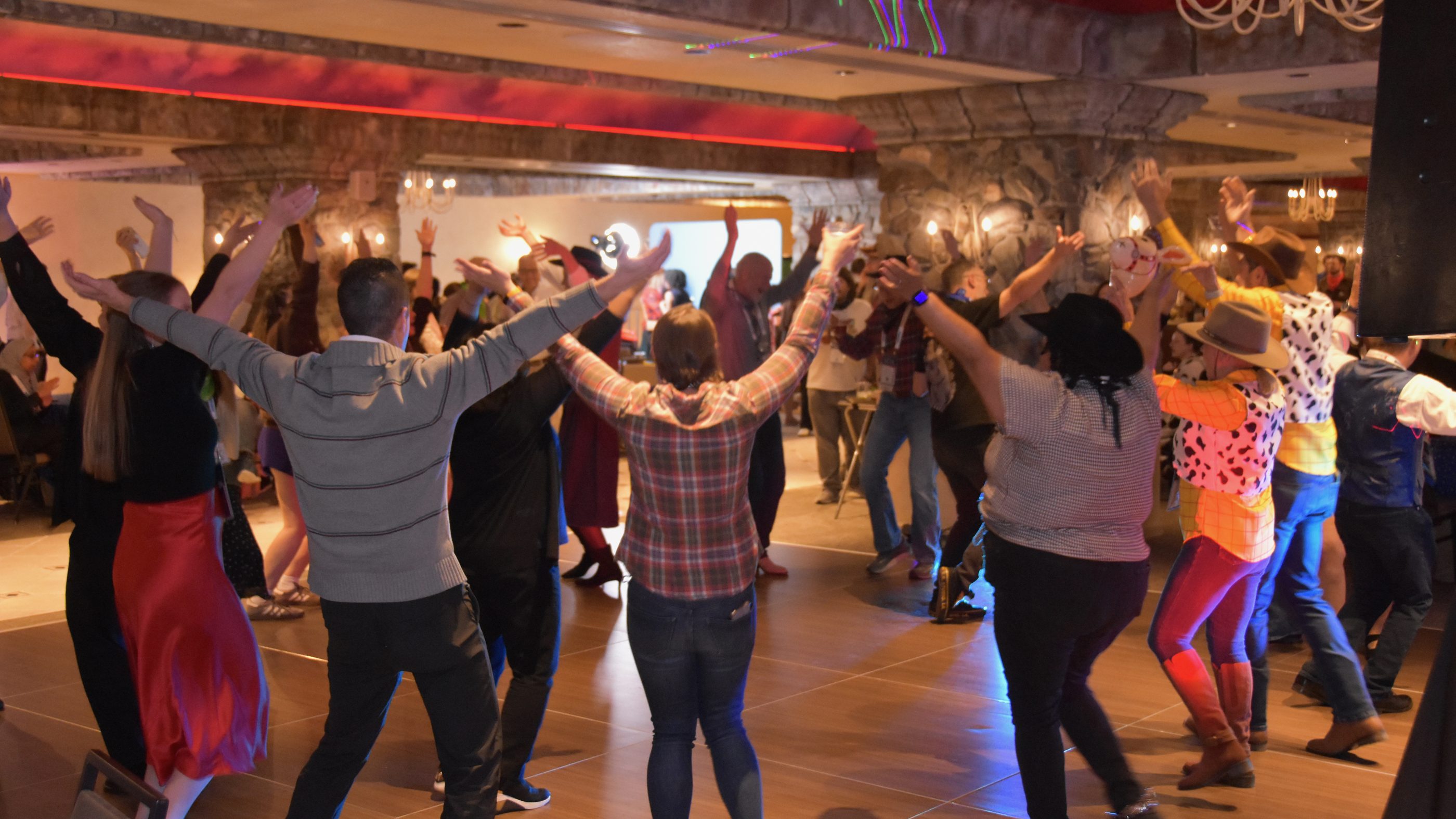 SciX Gala guests line dancing with their arms up at the Nugget Casino Resort