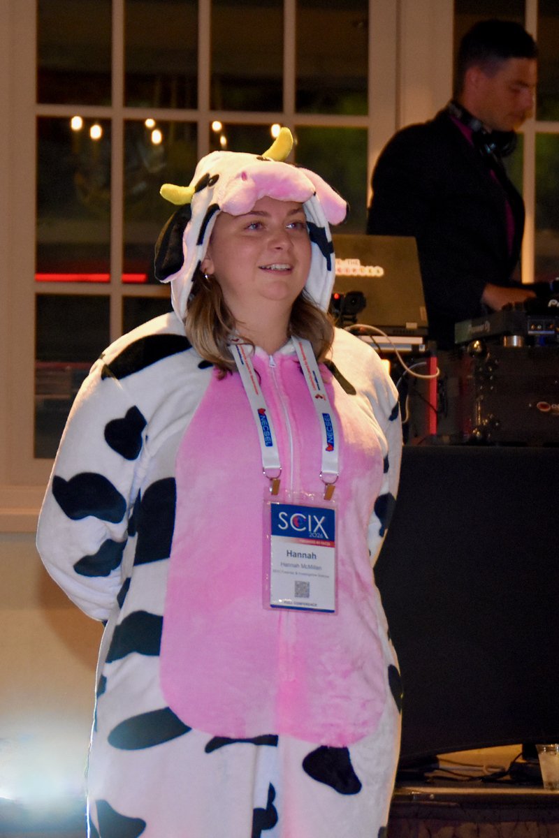 A smiling guest in a cow costume in front of my DJ booth