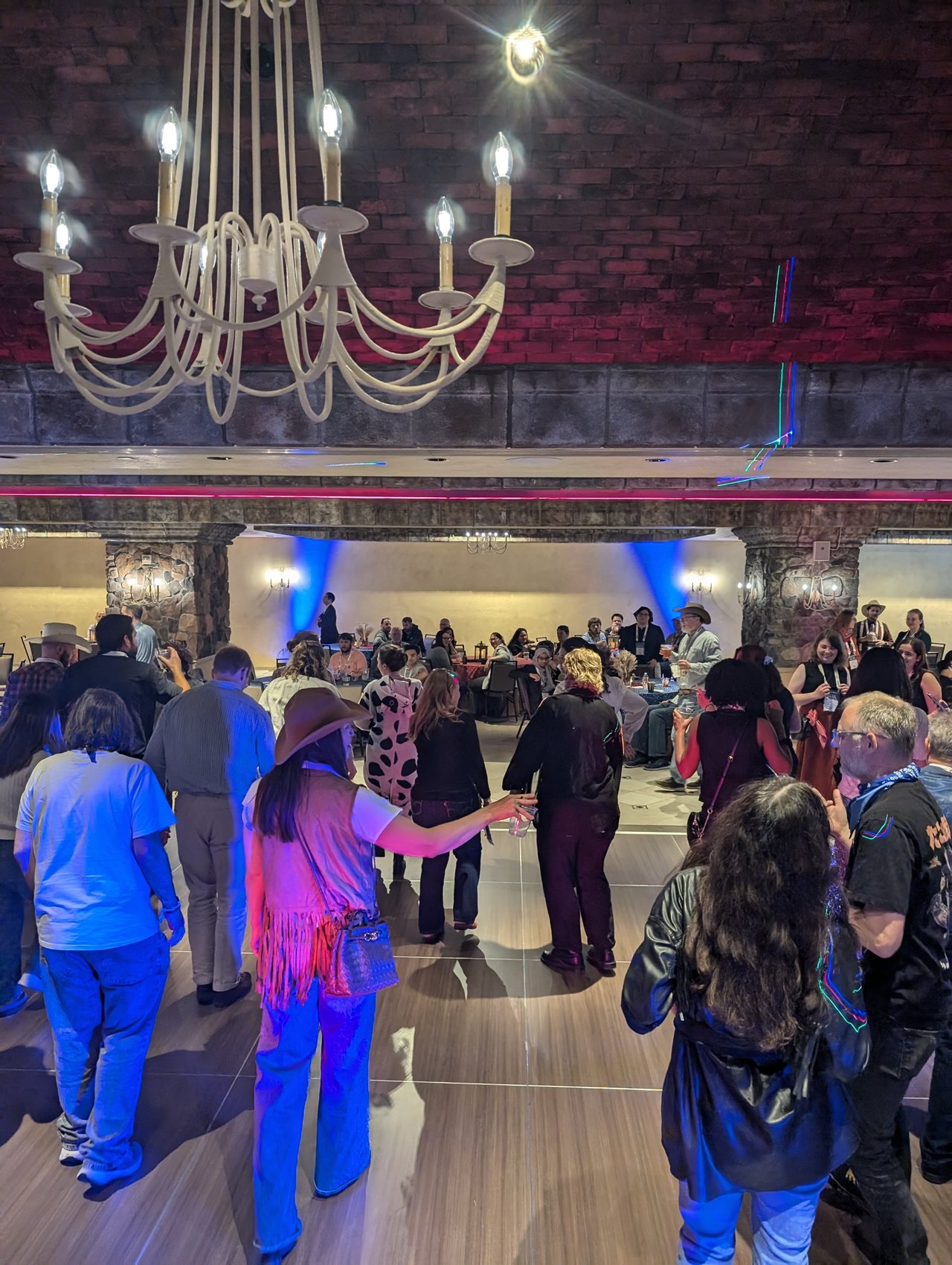 Guests dancing under the chandelier