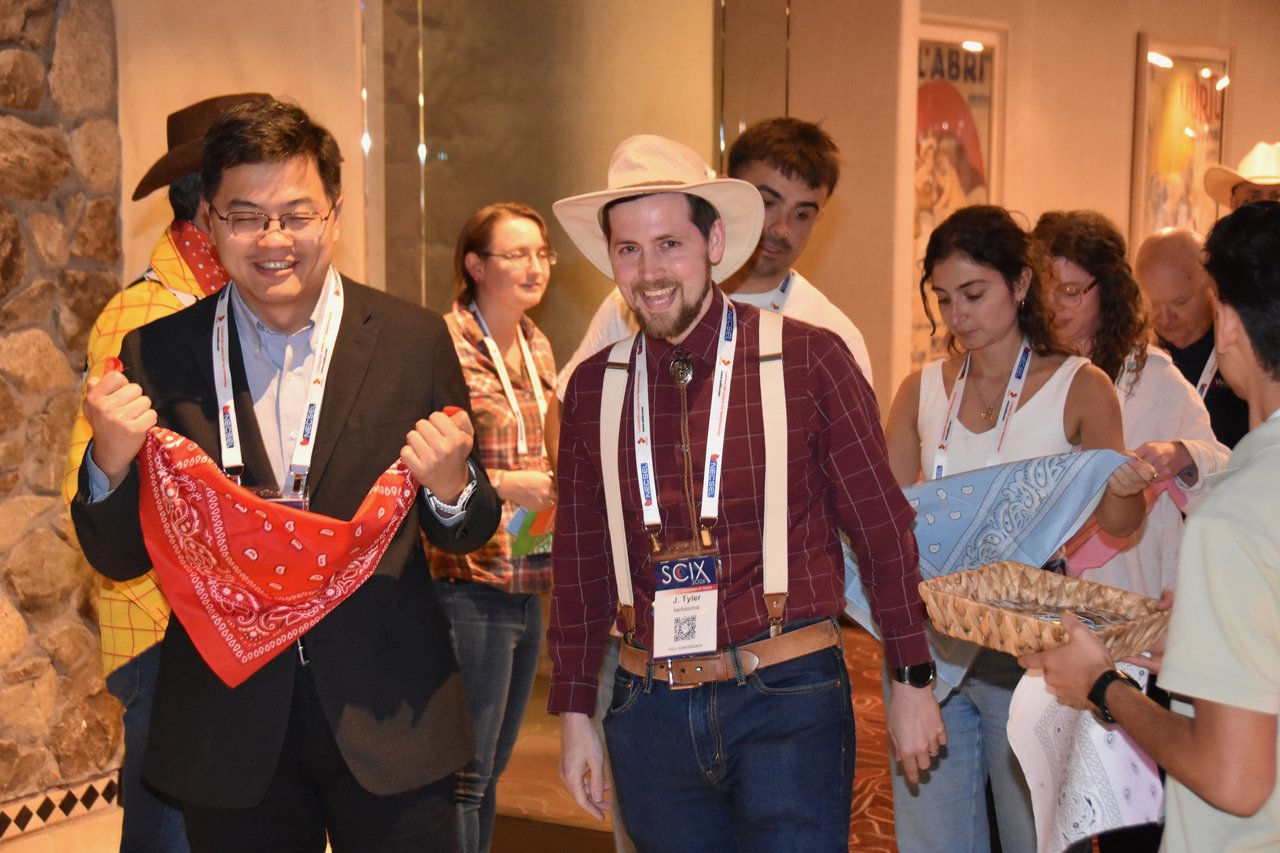 SciX Gala guests in western wear holding red bandanas at the entrance