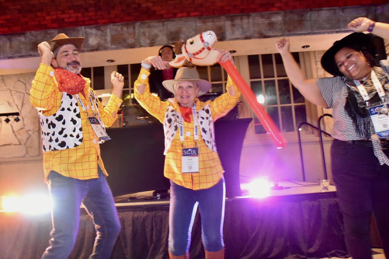 Guests in Woody costumes dancing with an inflatable stick horse