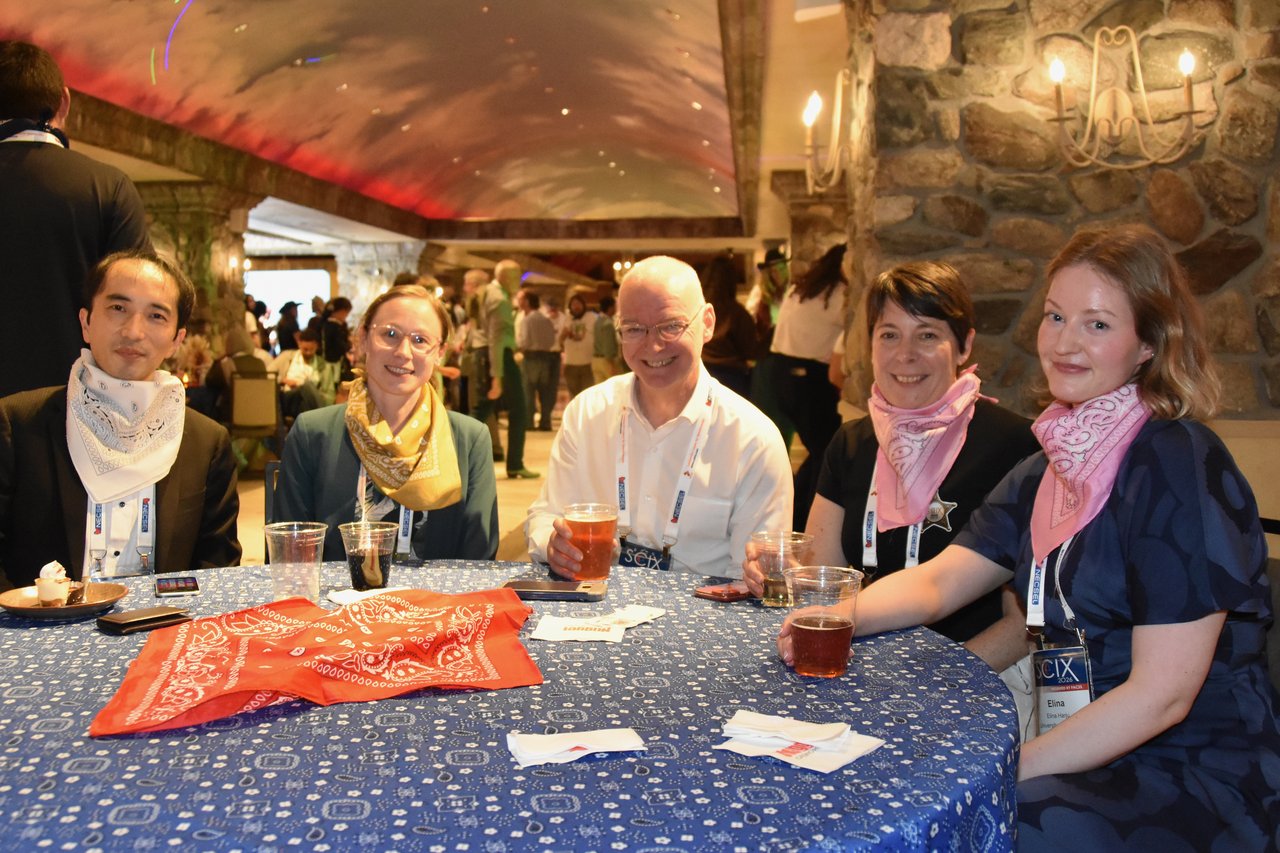 A table of SciX Gala guests in colorful bandanas