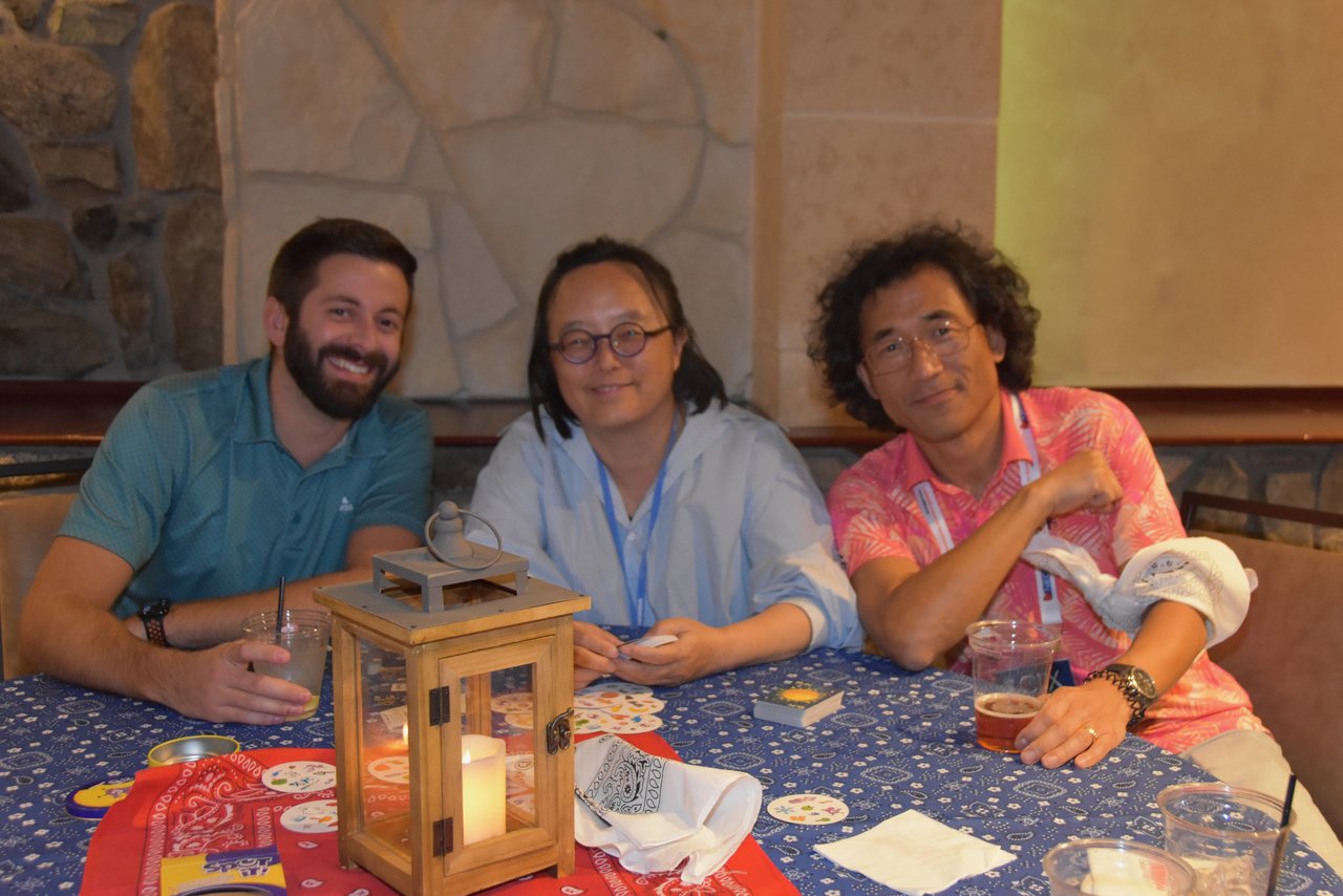 Three SciX Gala guests at a table with a lantern centerpiece