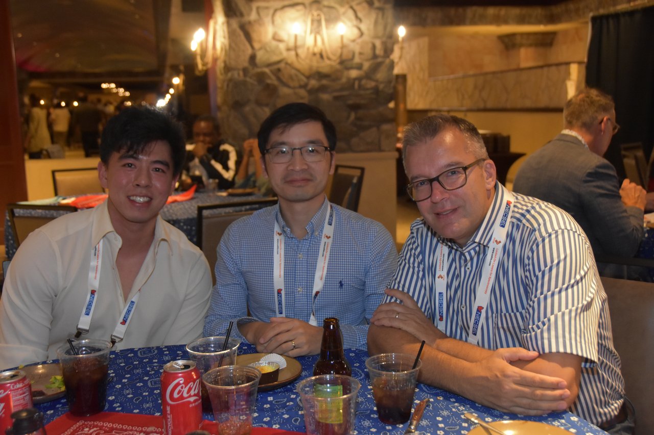 Three SciX Gala guests at a blue bandana table during dinner