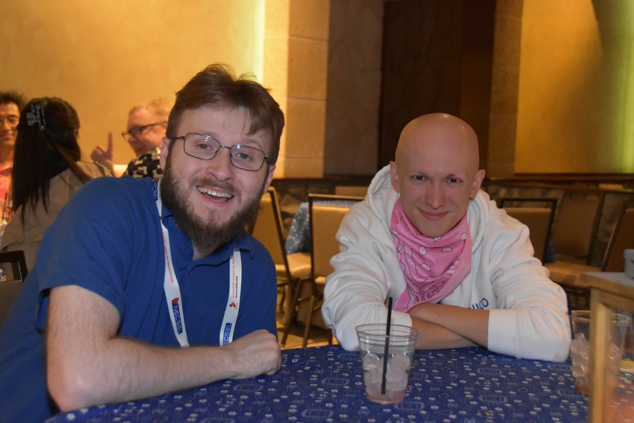 Two SciX Gala guests at a blue bandana table, one in a pink bandana