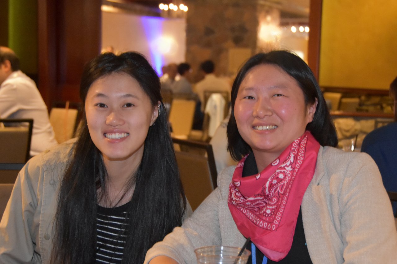Two SciX Gala guests smiling, one in a pink bandana
