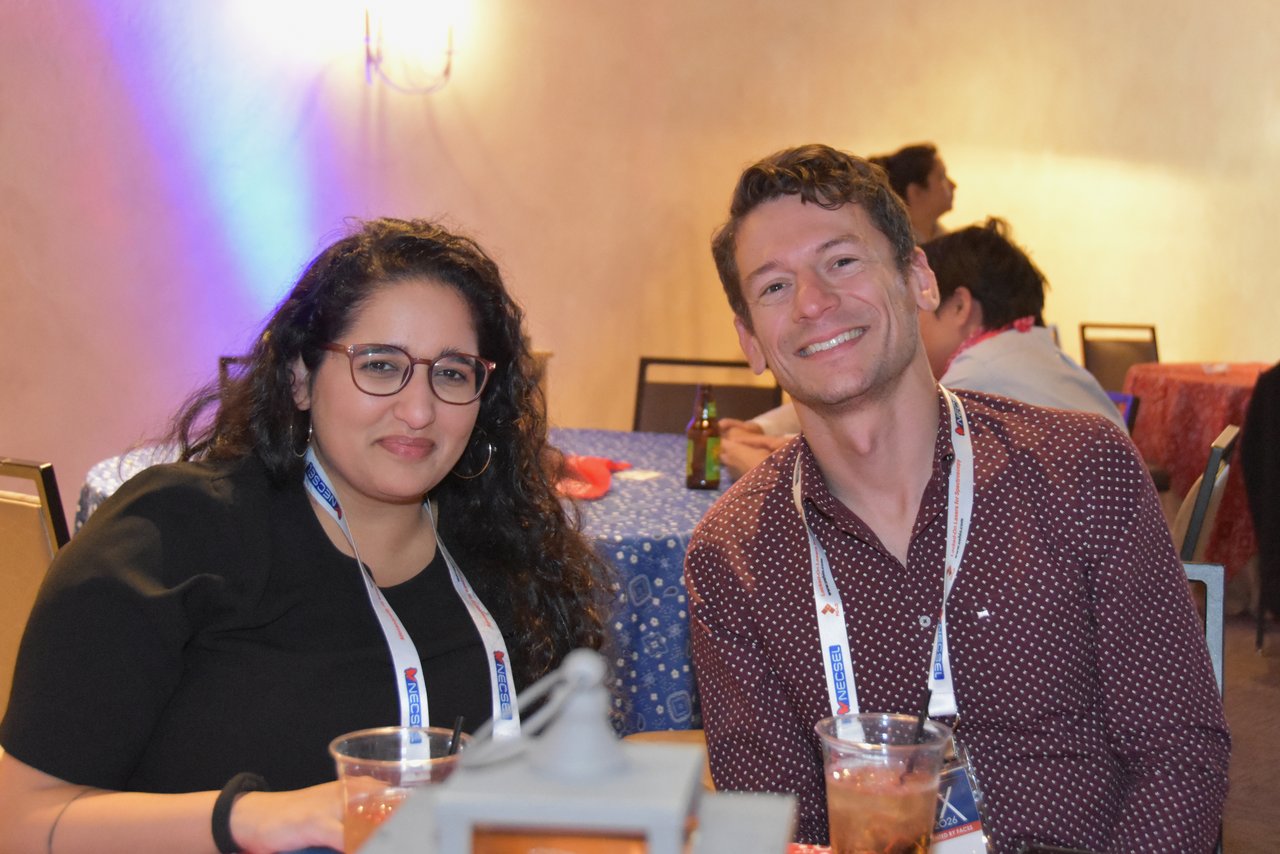 Two SciX Gala guests smiling at their table