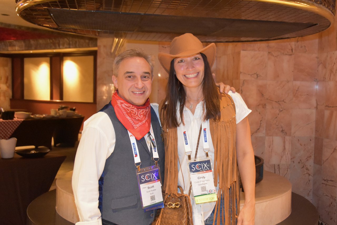 A couple in western hats and vests at the SciX Gala