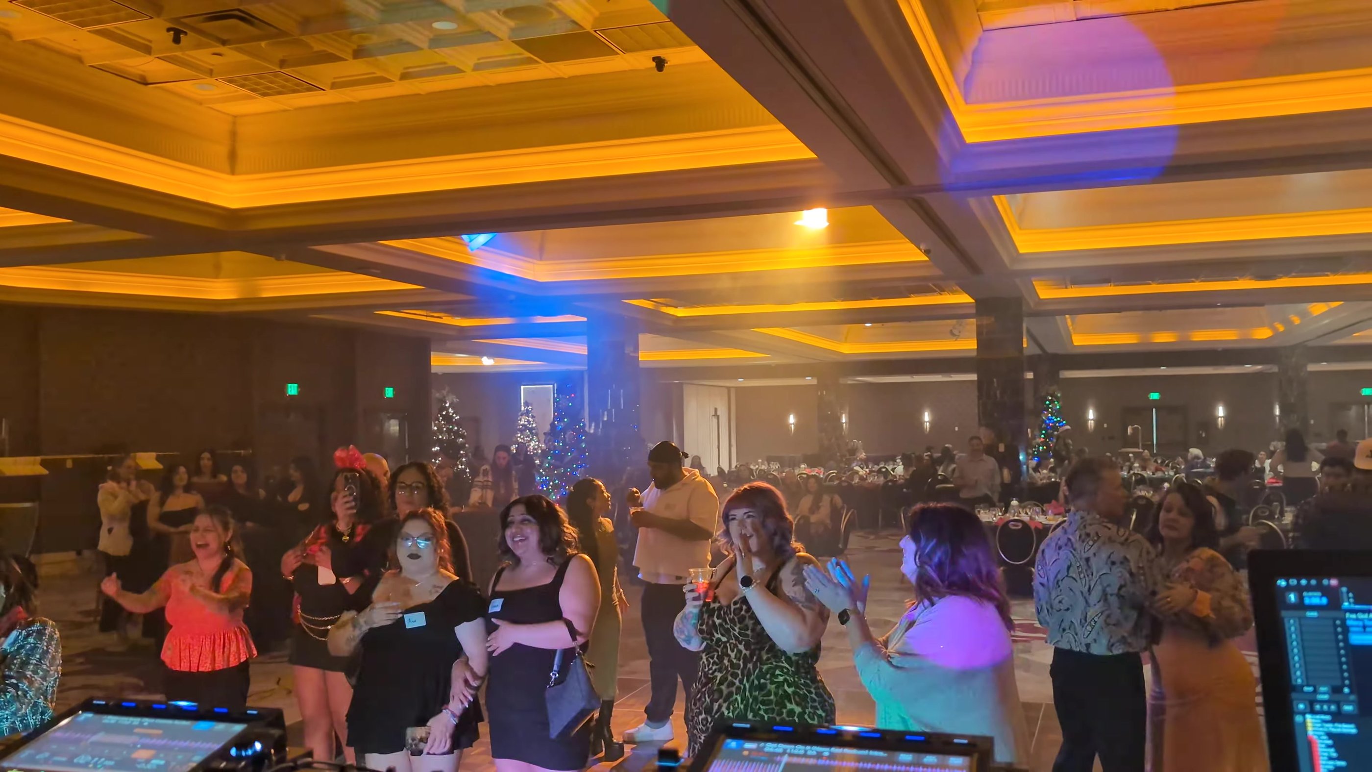 Sierra Air guests cheering on the dance floor at their holiday party in the Peppermill Naples Ballroom
