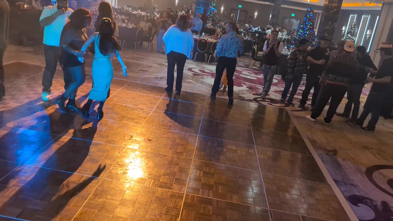 Sierra Air guests line dancing on the Naples Ballroom dance floor