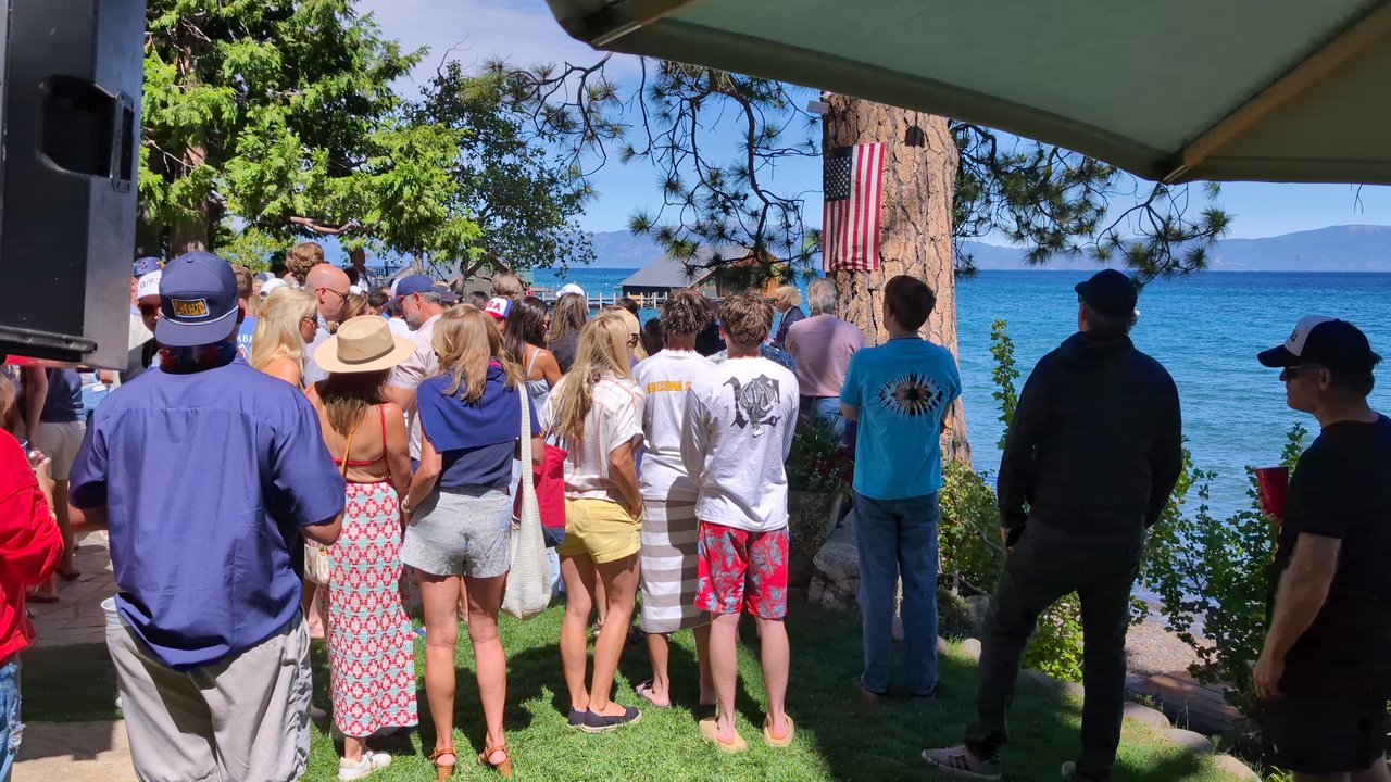 The crowd on the lawn beside the speaker, Lake Tahoe ahead of them