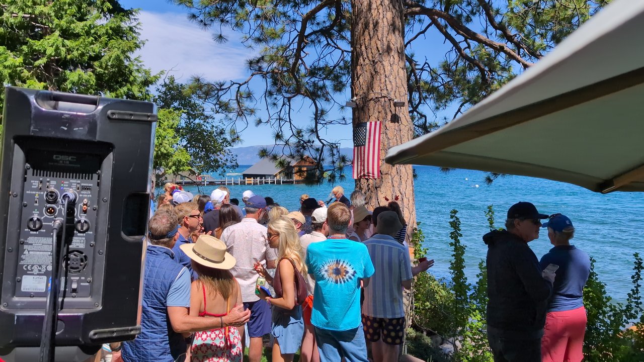 The crowd on the lawn facing Lake Tahoe, seen past the DJ speaker