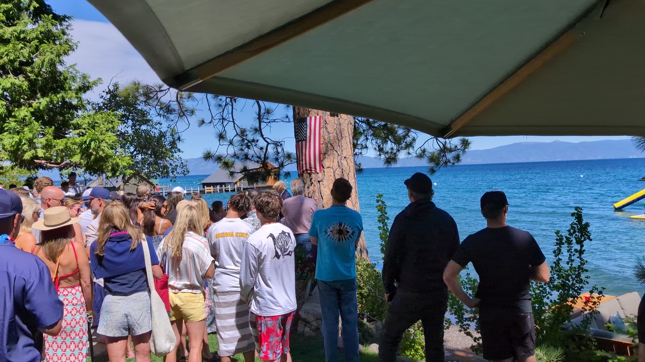The crowd on the lawn turned toward the show, Lake Tahoe behind them