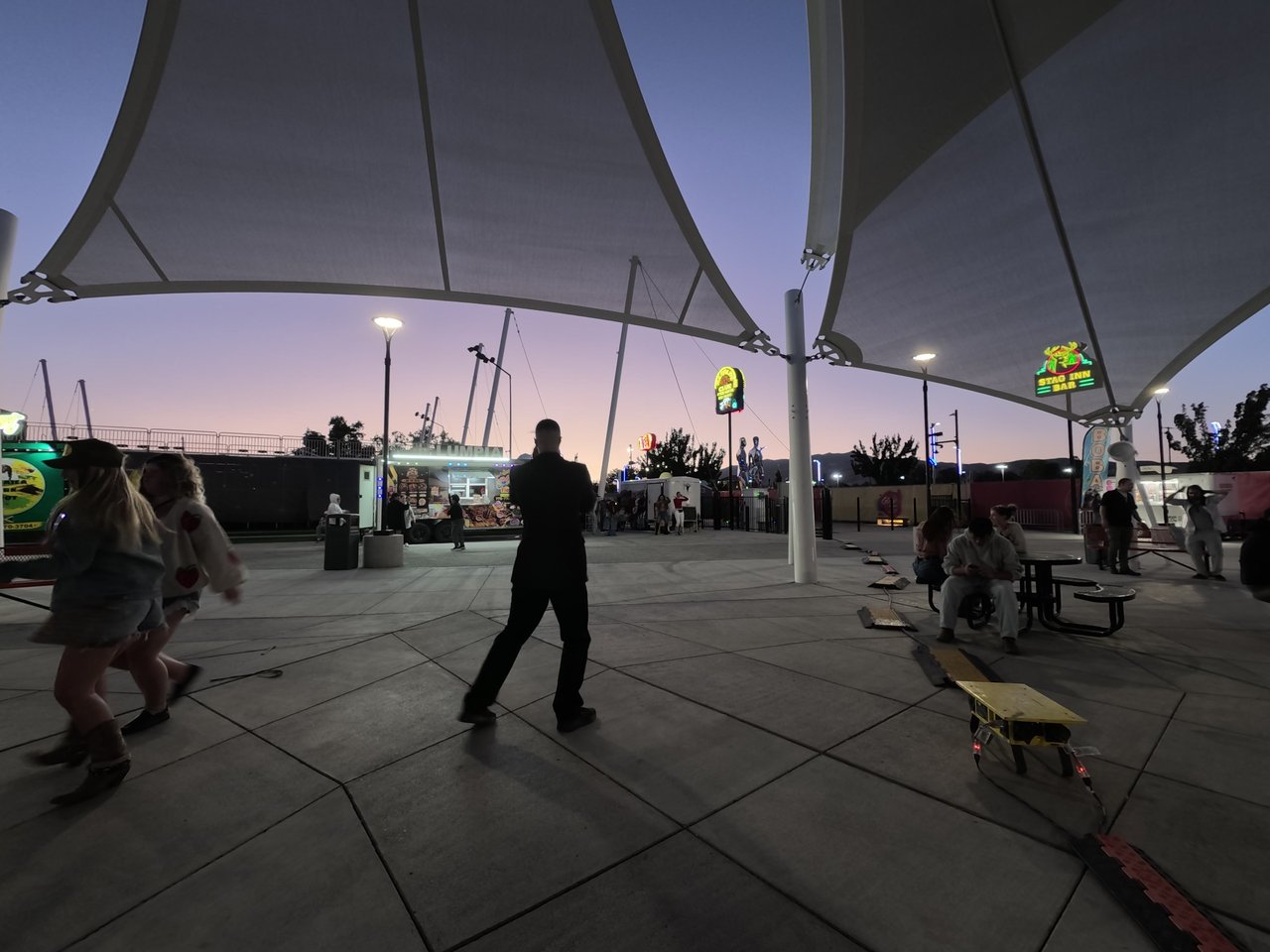 Guests line dancing at dusk at the Wanderlust Foodtrucks Festival