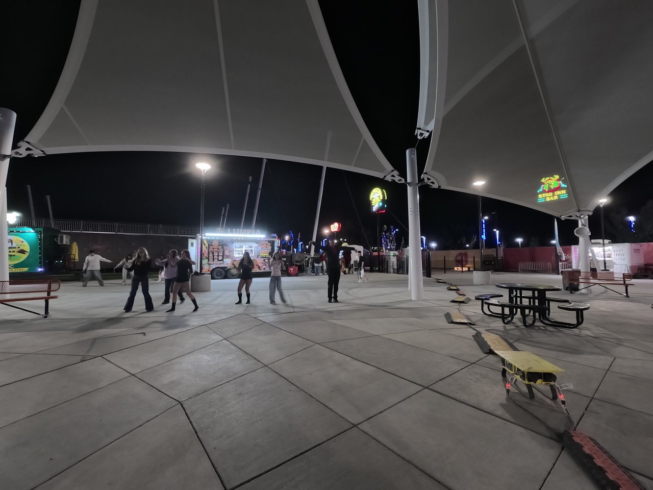 Line dancing at night in front of the food trucks at Wanderlust