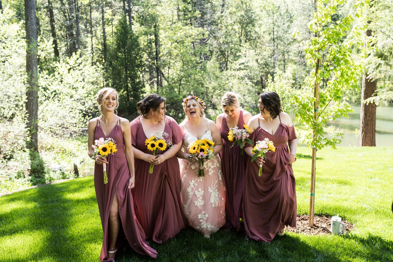 Abney walks across the lawn with her bridesmaids, all of them laughing