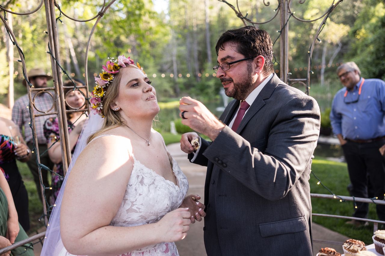 Chris feeds Abney a bite of wedding cake