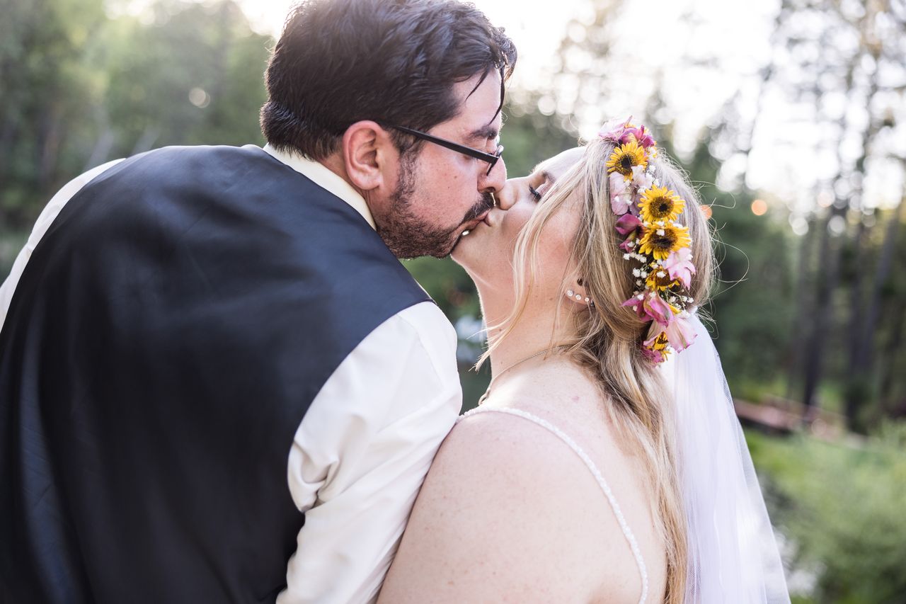 Chris leans in to kiss Abney as she tips her head back against his shoulder