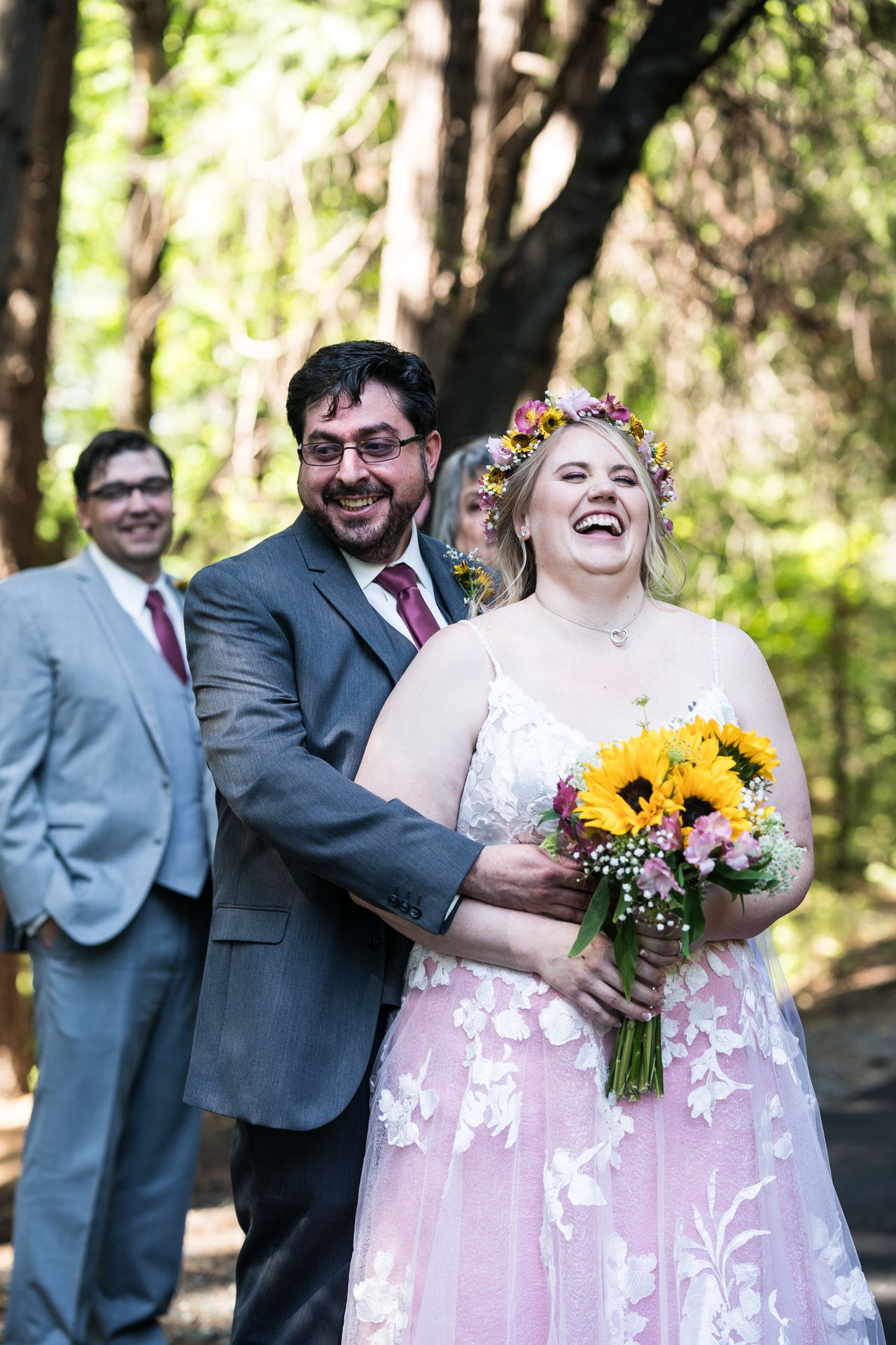 Chris wraps his arms around Abney from behind as she laughs