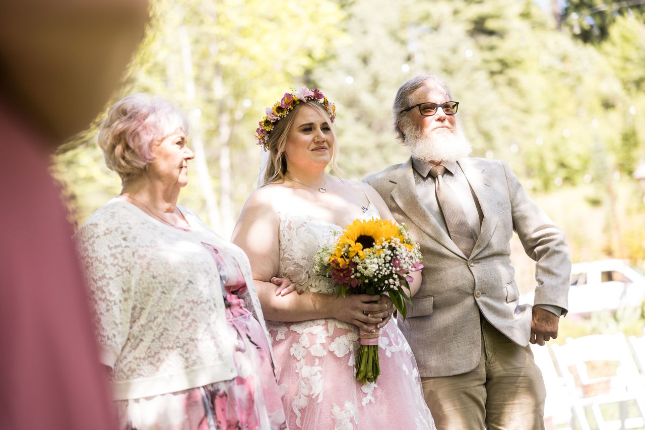 Abney stands between the two family members who walked her down the aisle