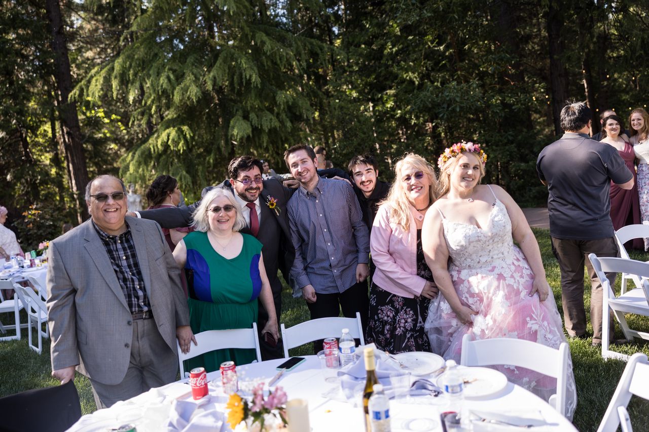 Abney leans in for a photo with a table of family members