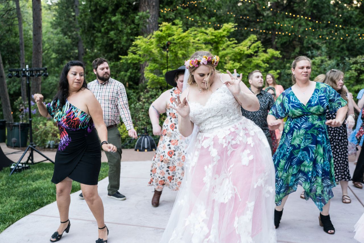 Abney leads a group dance on the patio with her guests dancing along behind her