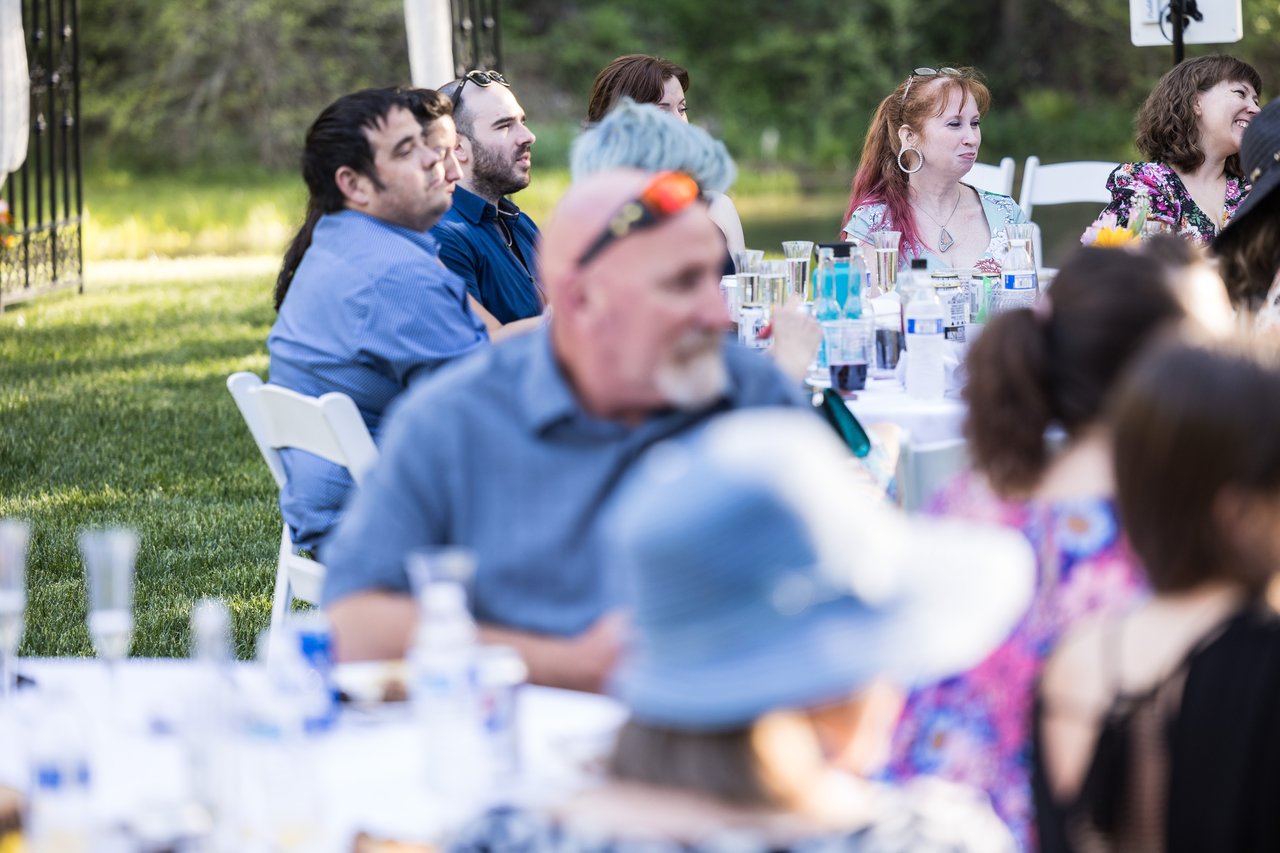 Guests listen to the toasts at their tables