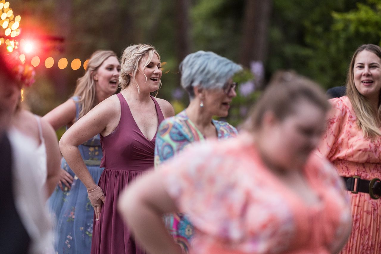 Guests sing along on the dance floor at dusk