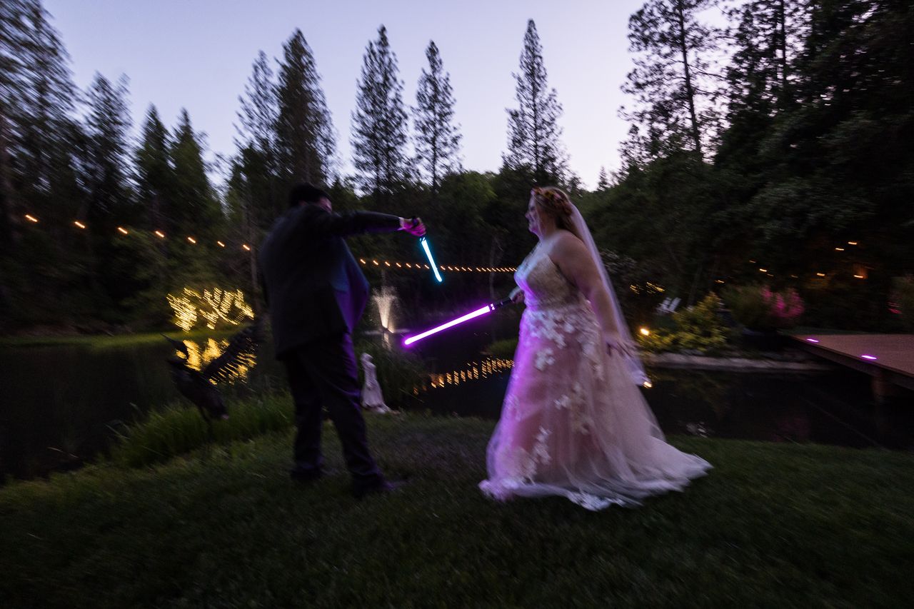 Abney and Chris in motion during their lightsaber duel beside the pond
