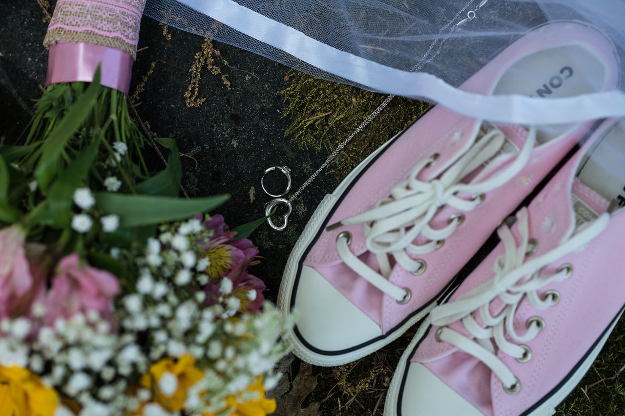 Abney's pink sneakers, the wedding rings and her veil laid out beside her bouquet
