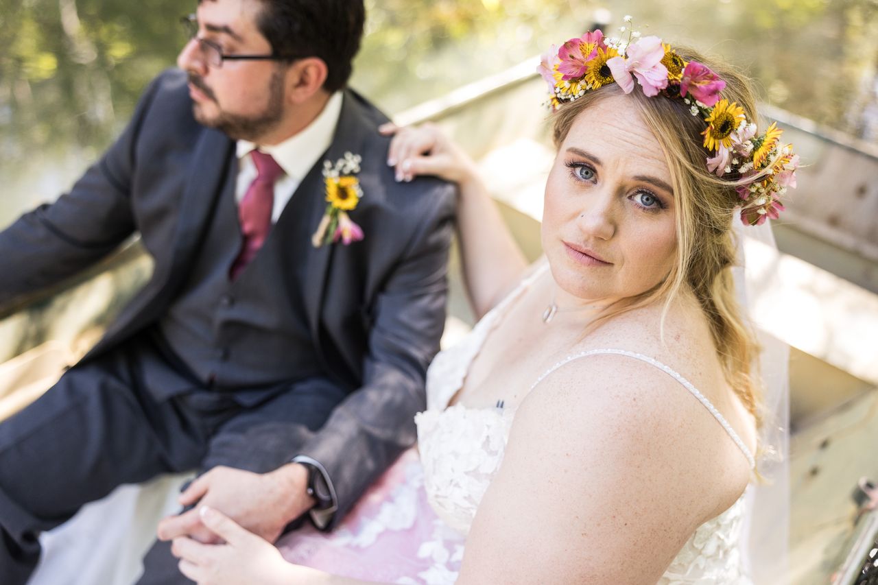 Abney looks into the camera from the rowboat while Chris sits beside her