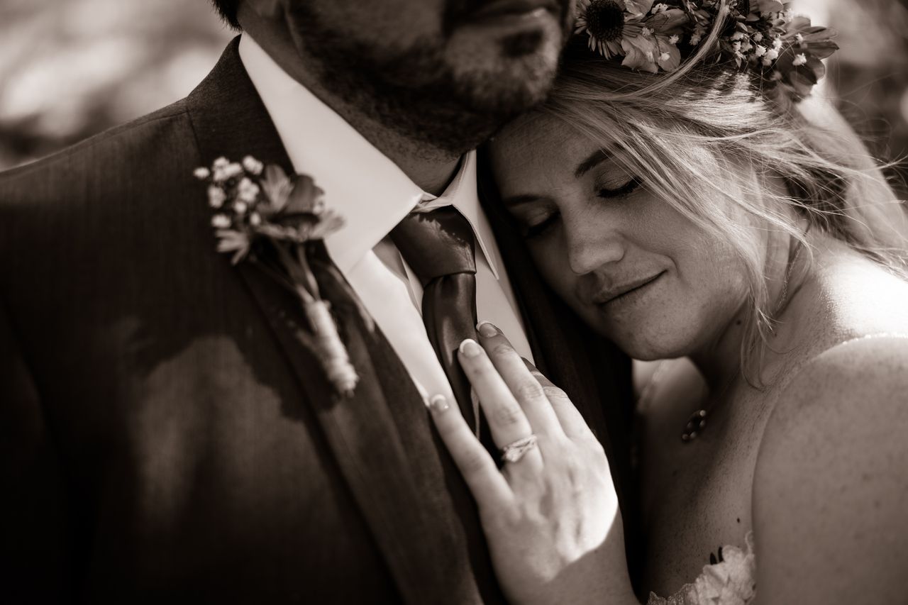 A sepia portrait of Abney resting her head against Chris's chest