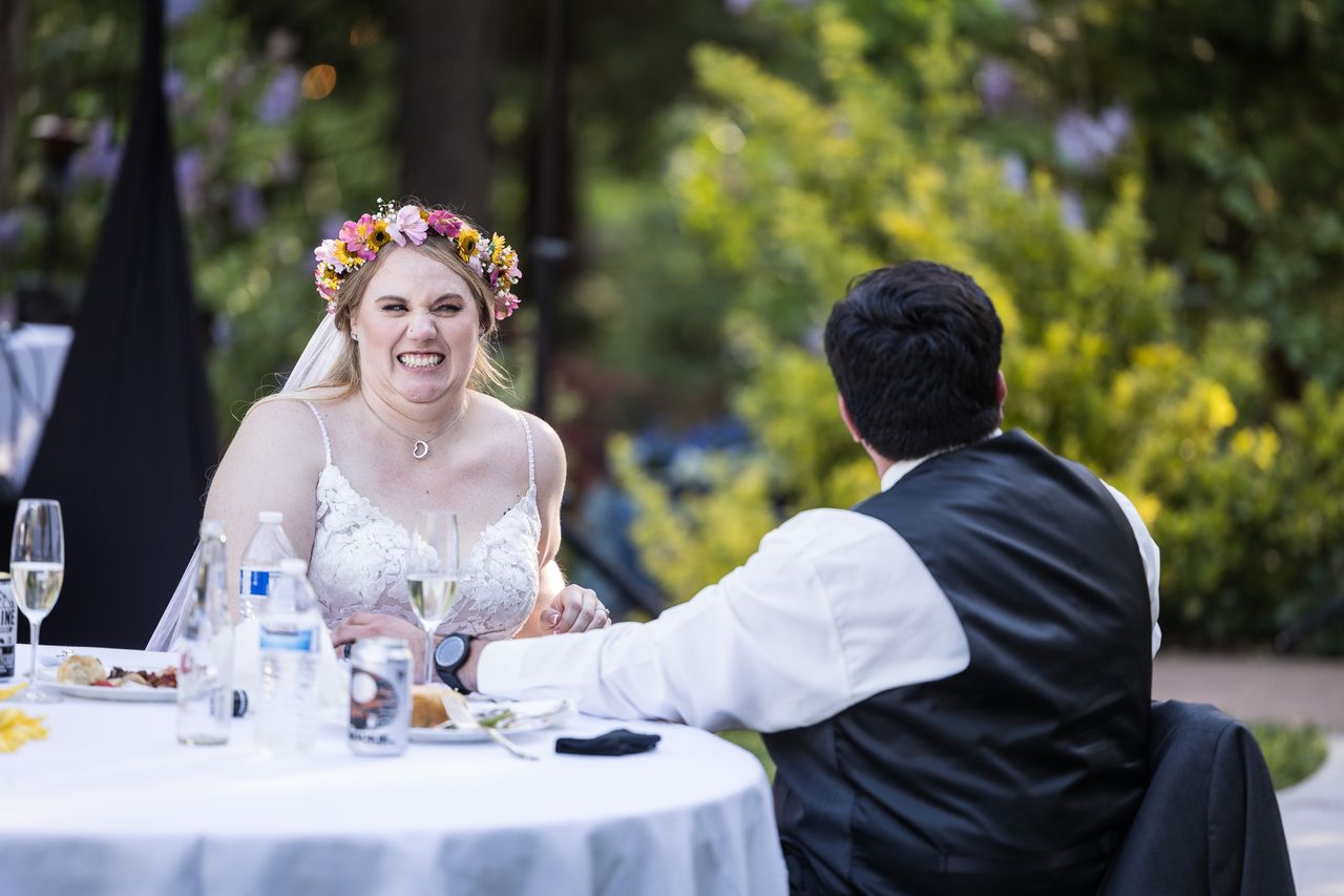 Abney laughs at the sweetheart table with Chris beside her