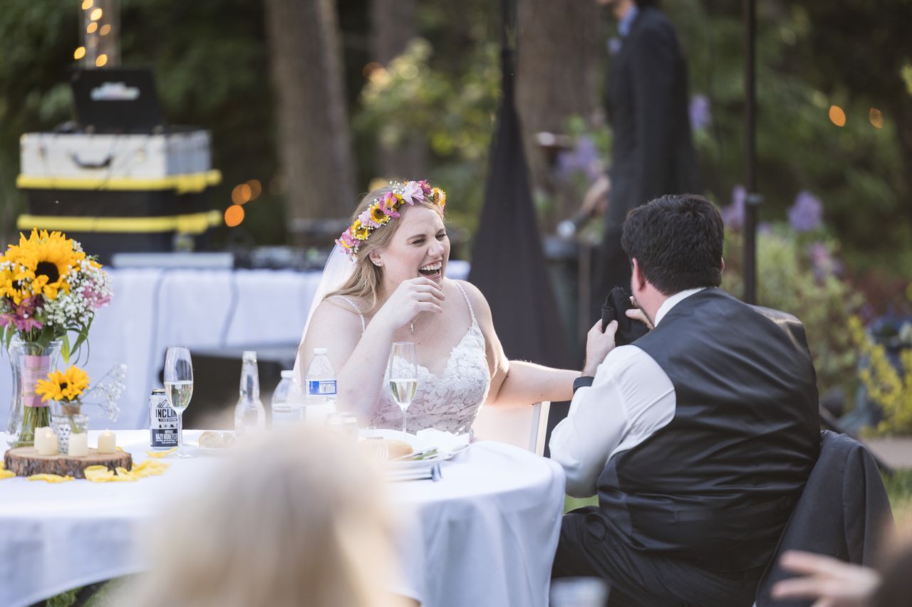 Abney laughs with Chris at their table during the toasts