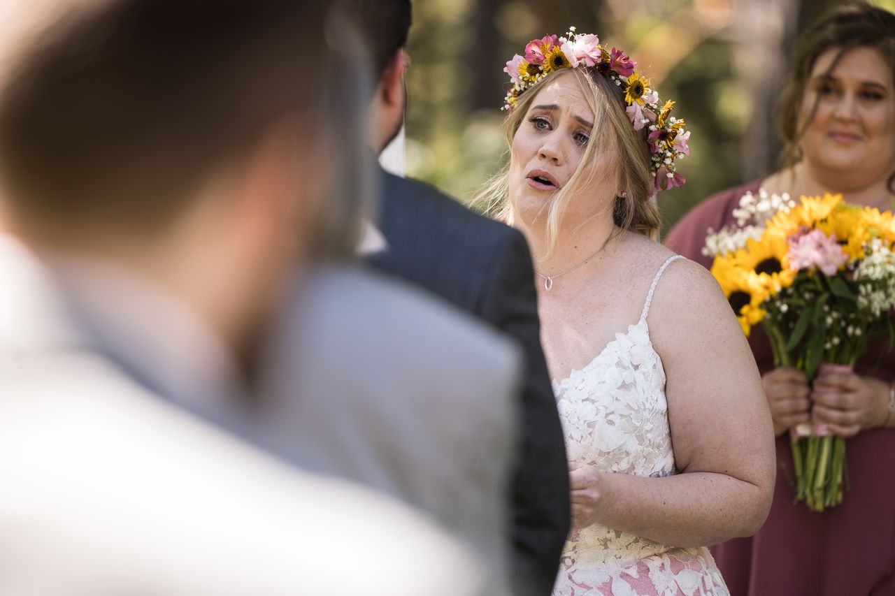 Abney tears up during the ceremony, seen over Chris's shoulder