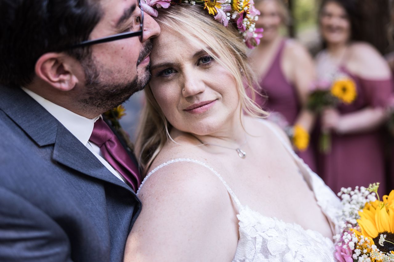Abney looks into the camera as Chris kisses her temple