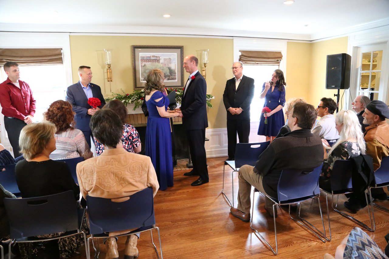 Guests seated in rows as the ceremony begins at the fireplace