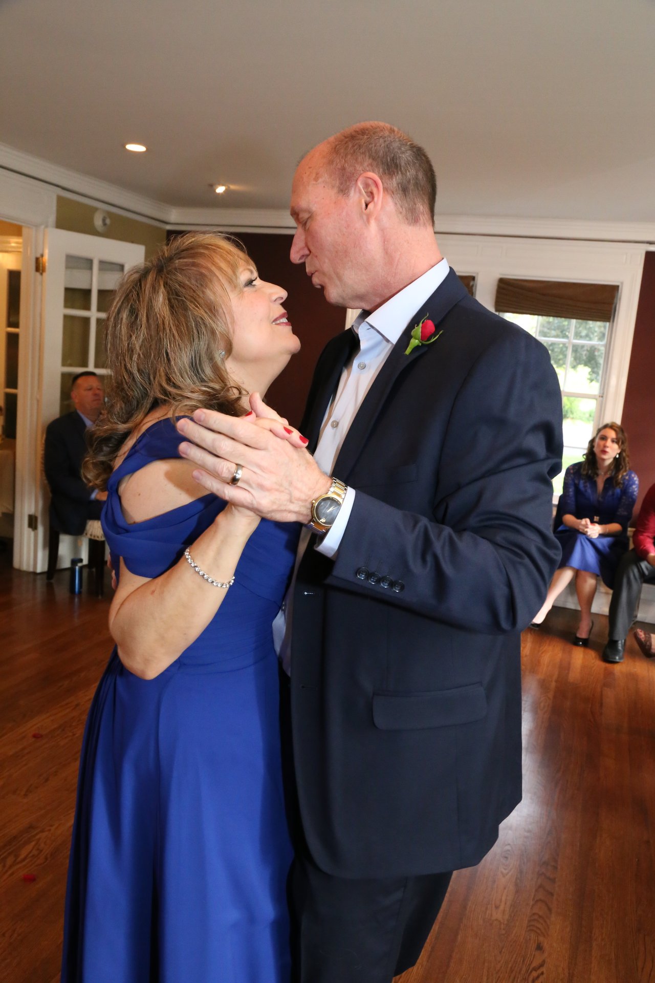 Alexanne and Tim dance close, smiling at each other