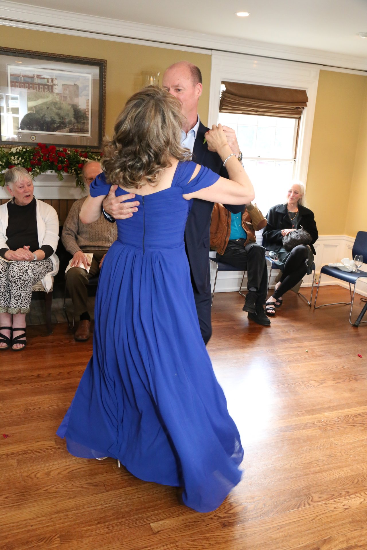 Alexanne's blue gown sweeps the floor as Tim holds her close