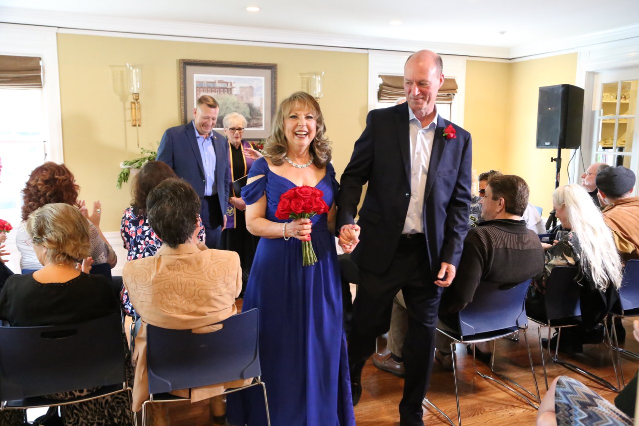 Alexanne and Tim walk back up the aisle hand in hand as guests clap