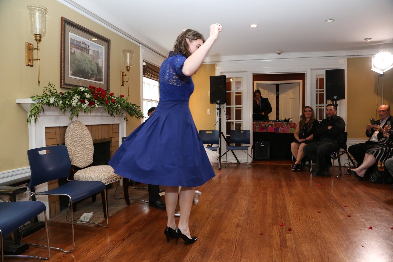 A guest in blue twirls on the dance floor