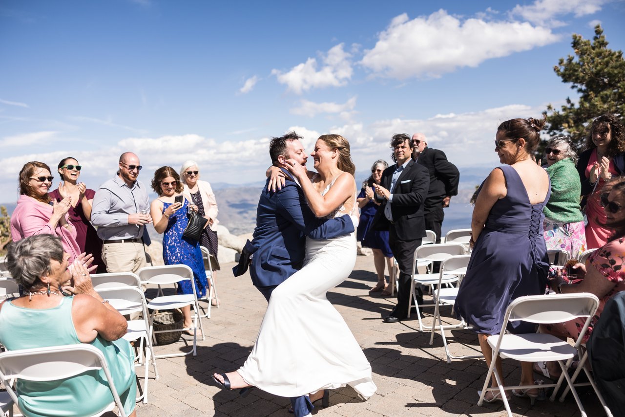 Robert dips Ali in the aisle as guests cheer